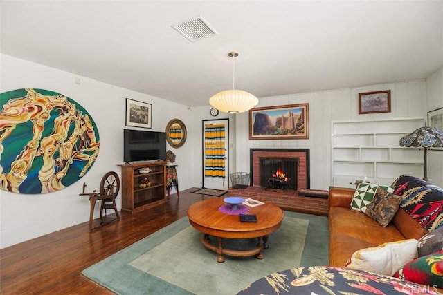 4365 Alta Vista Dr, Riverside, CA 92506 - living area with wood finished floors and a brick fireplace