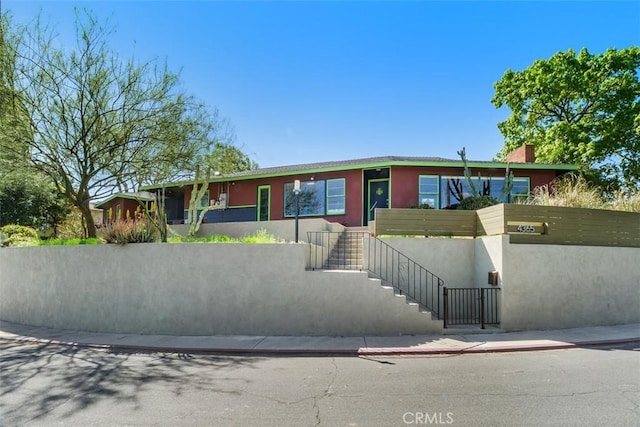 4365 Alta Vista Dr, Riverside, CA 92506 - view of front facade with stucco siding, stairway, and a chimney