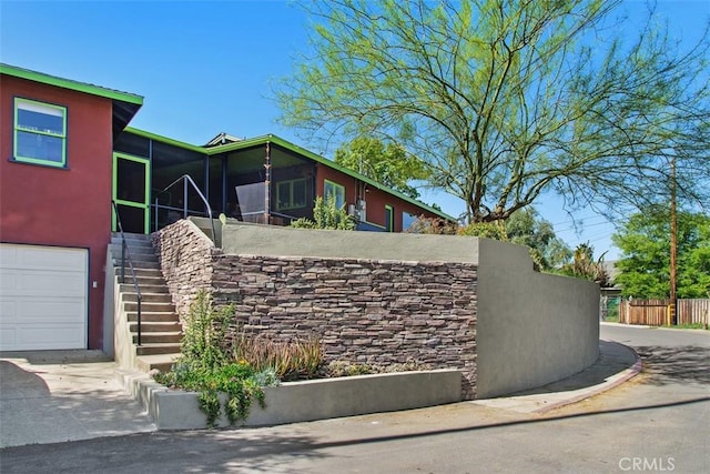 4365 Alta Vista Dr, Riverside, CA 92506 - view of property exterior with stairs, a sunroom, a garage, and stucco siding