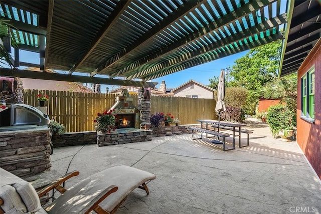 4365 Alta Vista Dr, Riverside, CA 92506 - fenced backyard with an outdoor stone fireplace, a patio, a pergola, and outdoor dining area