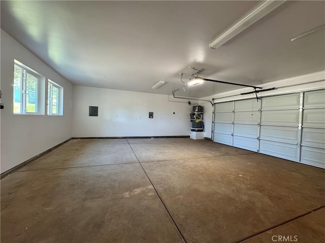 garage featuring baseboards, a garage door opener, strapped water heater, and electric panel