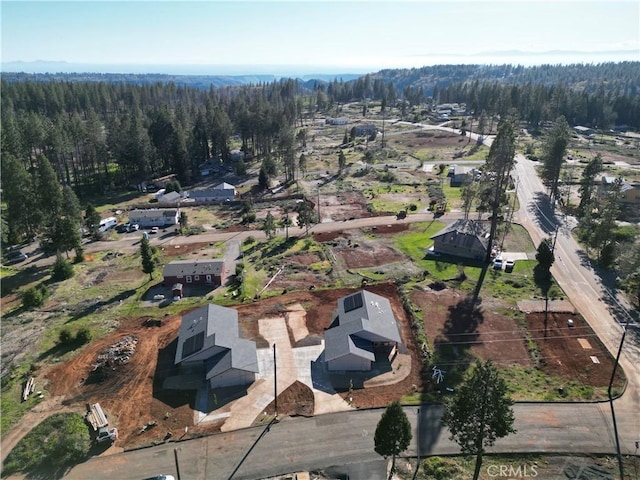 birds eye view of property featuring a view of trees