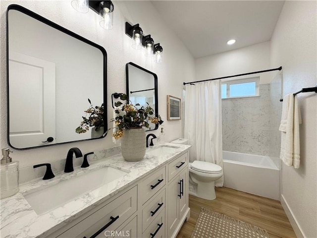 full bathroom with a sink, shower / bath combo, toilet, and wood finished floors