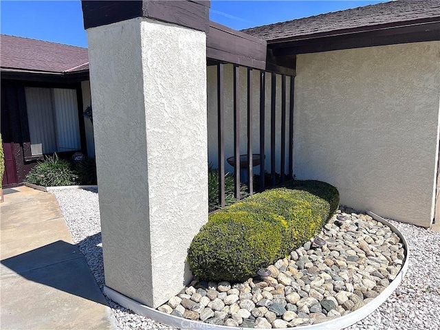 4971 W Gilman St, Banning, CA 92220 - view of side of home featuring stucco siding and a shingled roof