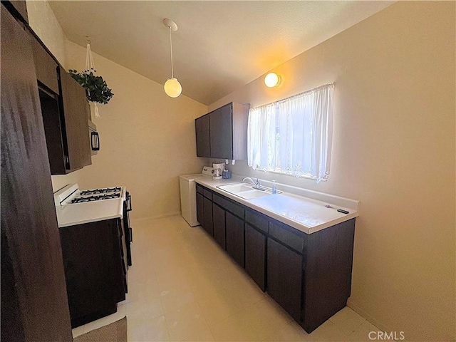 4971 W Gilman St, Banning, CA 92220 - kitchen featuring washer / dryer, a sink, lofted ceiling, stainless steel microwave, and light countertops