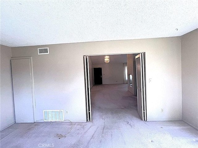 4971 W Gilman St, Banning, CA 92220 - empty room featuring light carpet, a textured ceiling, and baseboards