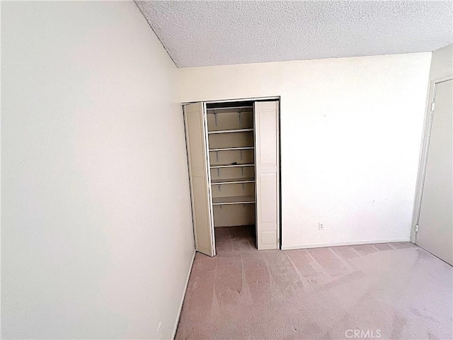 4971 W Gilman St, Banning, CA 92220 - unfurnished bedroom featuring carpet, a textured ceiling, a closet, and baseboards