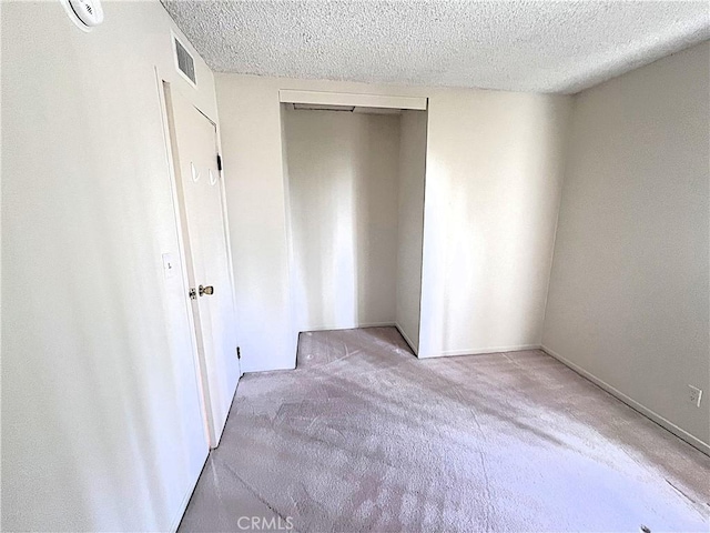 4971 W Gilman St, Banning, CA 92220 - unfurnished bedroom with a textured ceiling, carpet flooring, and a closet