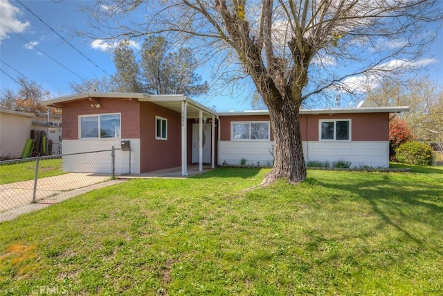 single story home with a front yard and fence