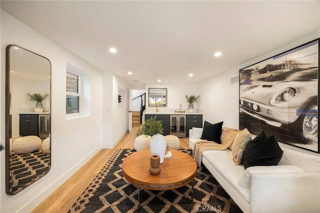 living area featuring recessed lighting, light wood-style floors, visible vents, a dry bar, and wine cooler