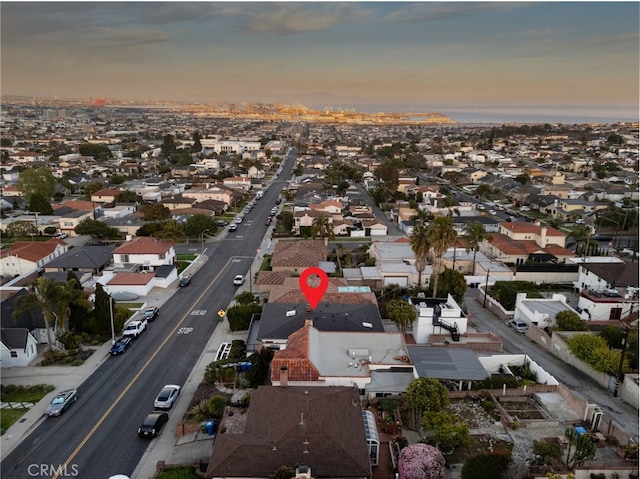 aerial view at dusk featuring a residential view