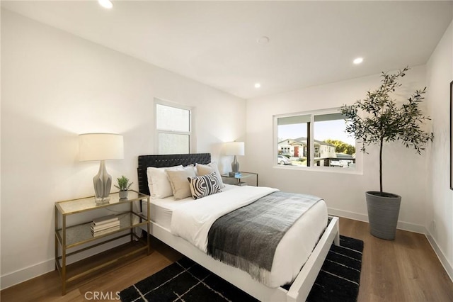 bedroom featuring recessed lighting, multiple windows, wood finished floors, and baseboards