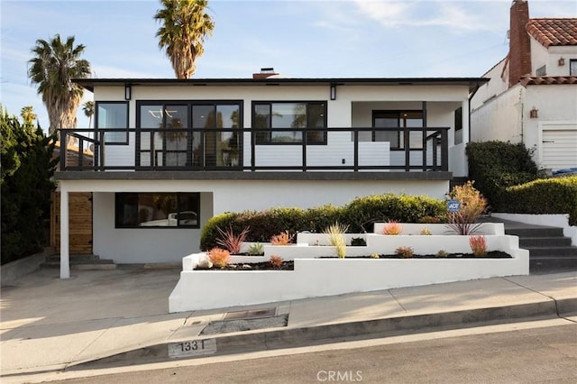 1331 W 17th St, San Pedro, CA 90732 - rear view of house featuring a balcony and stucco siding