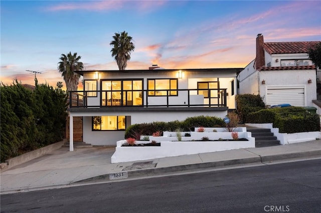 1331 W 17th St, San Pedro, CA 90732 - contemporary home with a balcony, stucco siding, and a chimney