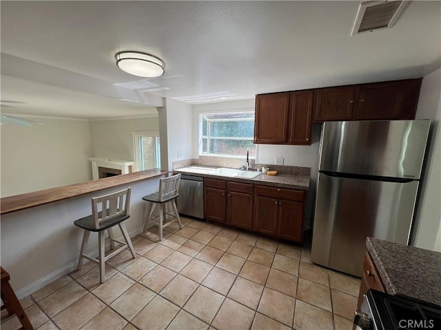 901 Vista Verde Cir, Duarte, CA 91010 - kitchen with stainless steel appliances, a sink, light tile patterned floors, crown molding, and dark countertops