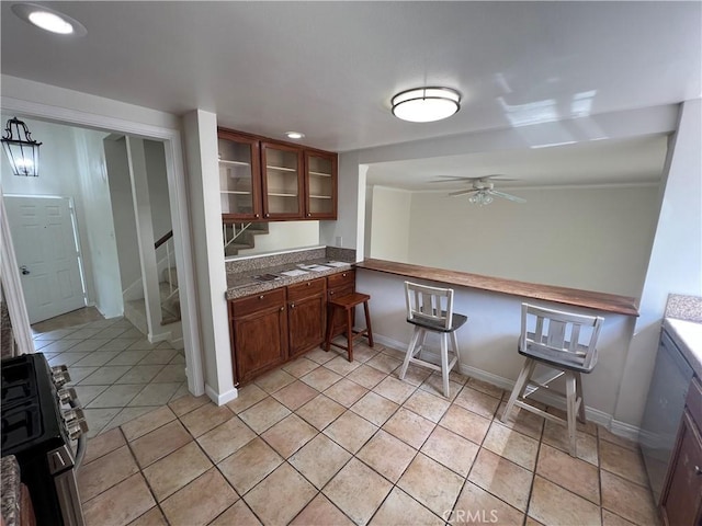 901 Vista Verde Cir, Duarte, CA 91010 - kitchen with brown cabinetry, glass insert cabinets, baseboards, a ceiling fan, and recessed lighting