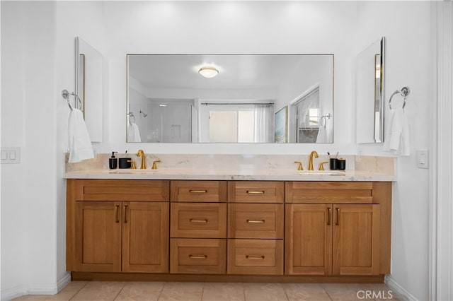 bathroom with double vanity, a sink, walk in shower, and tile patterned floors