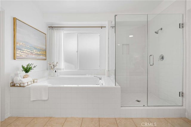 full bath featuring tile patterned flooring, a shower stall, and a garden tub