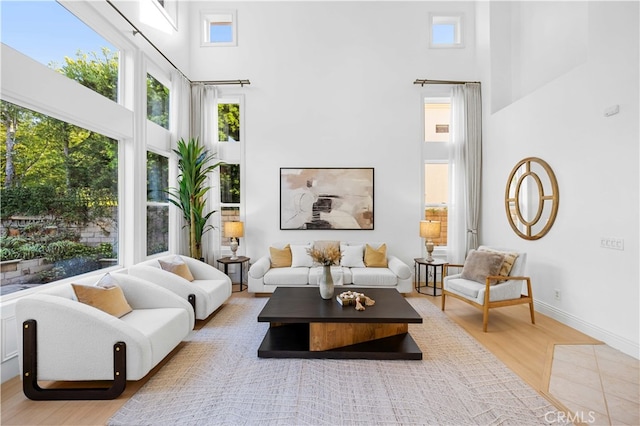 31232 Calle Bolero, San Juan Capistrano, CA 92675 - living room featuring a towering ceiling, plenty of natural light, wood finished floors, and baseboards