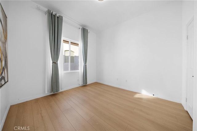 empty room with light wood-style floors and baseboards