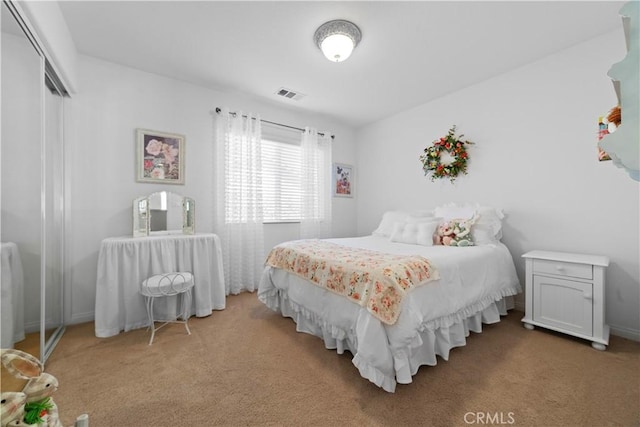 bedroom featuring carpet floors, a closet, and visible vents