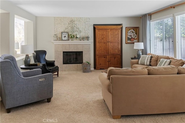 living room featuring light carpet and a tile fireplace