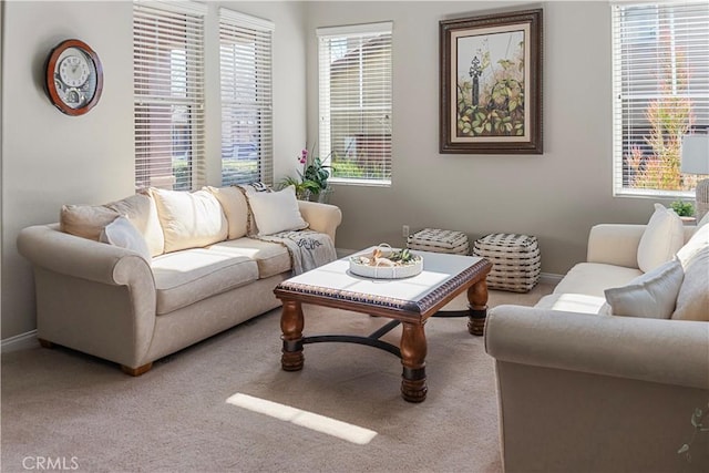 carpeted living room with baseboards