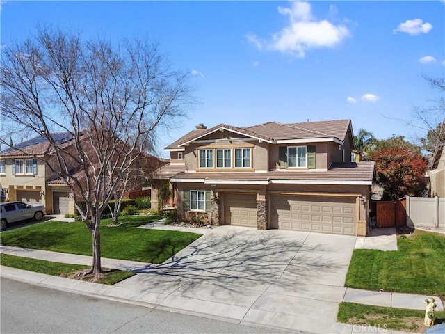 view of front of property featuring fence, a garage, concrete driveway, a front yard, and stucco siding
