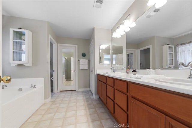 full bath with a bath, double vanity, visible vents, and a sink