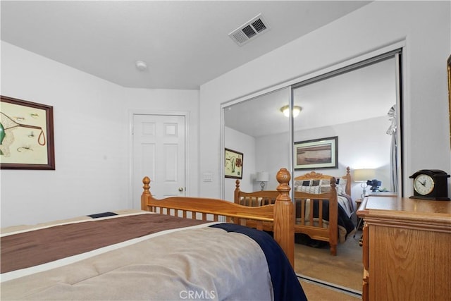 bedroom with visible vents, a closet, and carpet