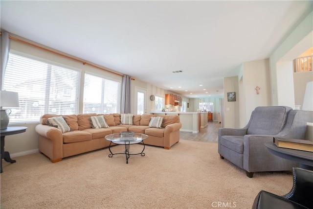 living room featuring light carpet, baseboards, and recessed lighting