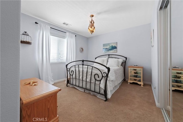 bedroom with baseboards, light colored carpet, and visible vents