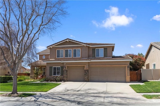 view of front of property featuring concrete driveway, stucco siding, fence, an attached garage, and a front lawn