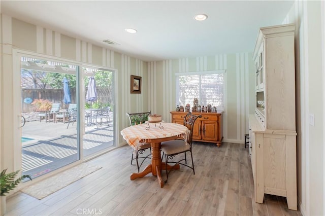 dining space with visible vents, wallpapered walls, recessed lighting, and light wood-type flooring