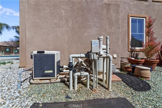 exterior details featuring stucco siding and mail area