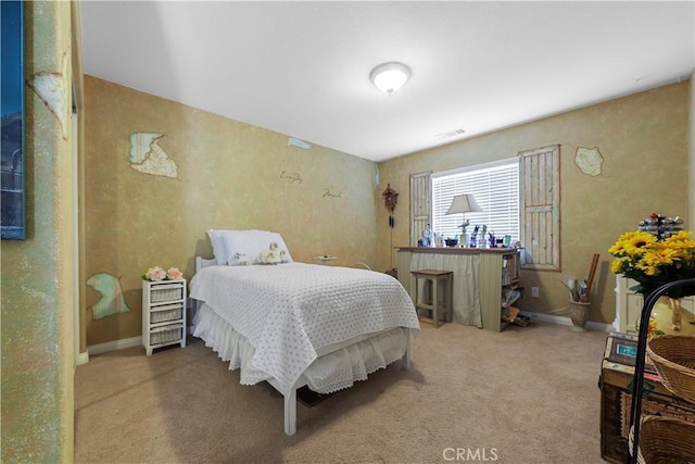 carpeted bedroom featuring baseboards and visible vents