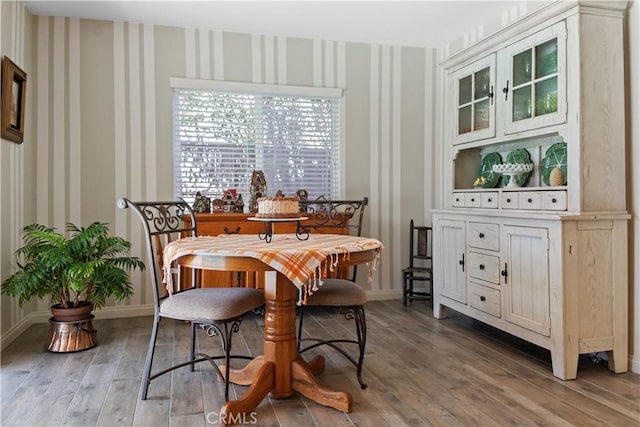 dining area with baseboards and light wood-type flooring