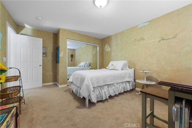 bedroom featuring baseboards, a closet, and light carpet
