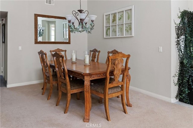 dining area featuring an inviting chandelier, baseboards, light colored carpet, and visible vents