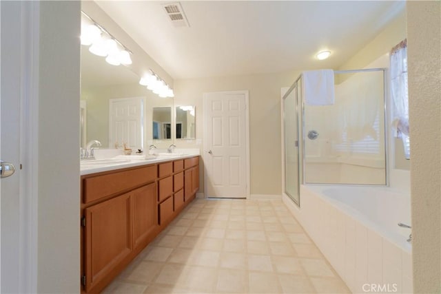 bathroom featuring a sink, a stall shower, a bathtub, visible vents, and double vanity