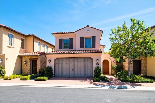 54 Trotter, Irvine, CA 92602 - mediterranean / spanish-style house with a tiled roof, an attached garage, stucco siding, and driveway