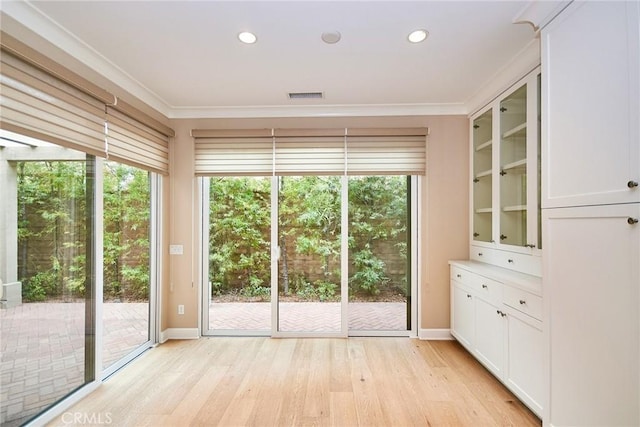 54 Trotter, Irvine, CA 92602 - unfurnished dining area featuring light wood-type flooring, ornamental molding, and recessed lighting