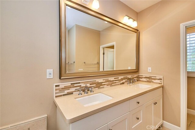 54 Trotter, Irvine, CA 92602 - bathroom with double vanity and decorative backsplash