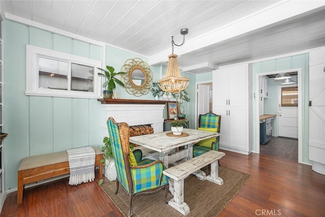 27 A Surfside Ave, Surfside, CA 90743 - dining area with dark wood finished floors, a chandelier, a decorative wall, and wood ceiling