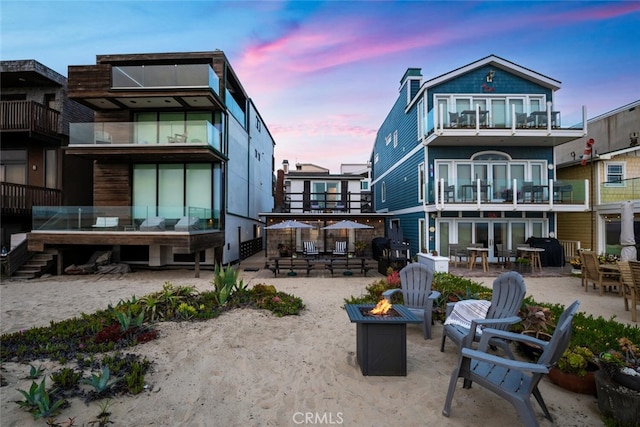 27 A Surfside Ave, Surfside, CA 90743 - back of property featuring an outdoor fire pit, a patio area, and a chimney