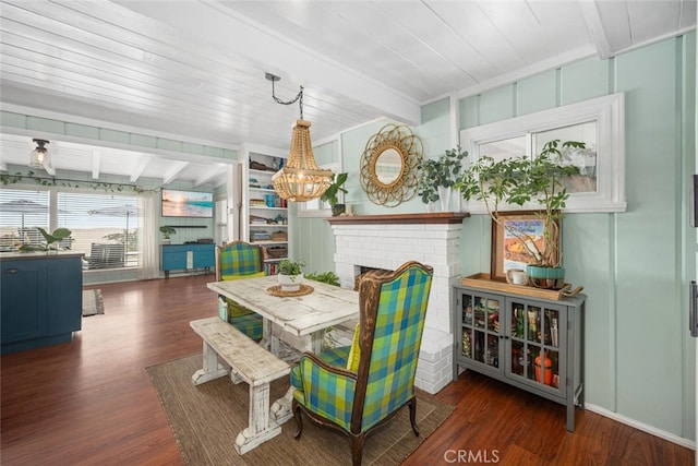 27 A Surfside Ave, Surfside, CA 90743 - dining room with beam ceiling, wood finished floors, a chandelier, and a brick fireplace