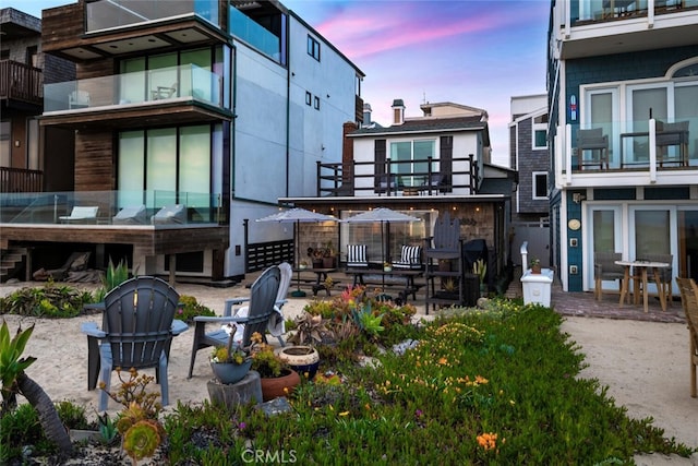 27 A Surfside Ave, Surfside, CA 90743 - back of house at dusk featuring a patio and a balcony