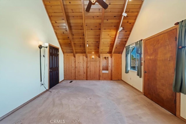 additional living space with wood ceiling, a ceiling fan, light carpet, lofted ceiling with beams, and baseboards