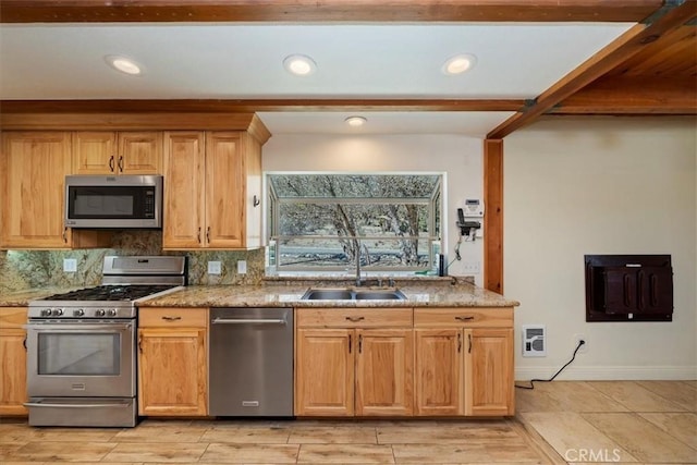 kitchen featuring light stone counters, backsplash, a sink, stainless steel appliances, and beamed ceiling