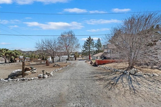 view of street with gravel driveway